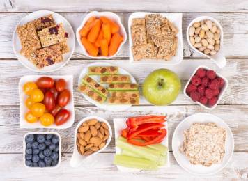 62916253-healthy-snacks-on-wooden-table-top-view